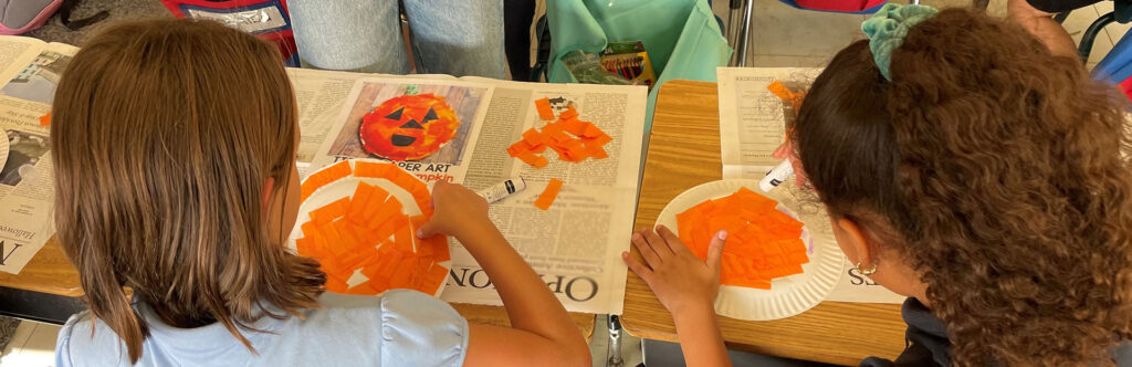 Two students work together on an art project